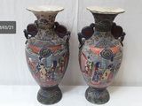 two vases that are sitting on a table