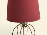 a lamp that has a red shade on top of it