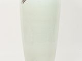 a large white vase with a gold leaf on it