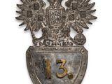 an old metal shield with a coat of arms and two birds on it