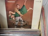 a person holding a box full of vinyl records