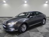 a picture of a grey car parked in a garage
