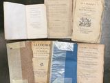 several old books sitting on top of a table next to each other