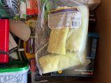 a cardboard box filled with cleaning supplies and a clock