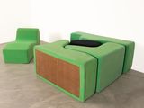 a green chair and a green ottoman in a room