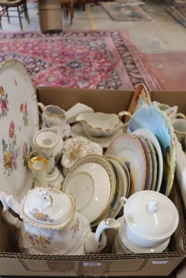 a box full of china plates and bowls on the floor