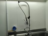 a kitchen sink with a faucet and a faucet attached to it