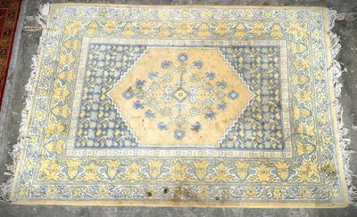 an old rug with a yellow and blue design on it