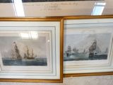 two framed pictures of ships on display in a glass case