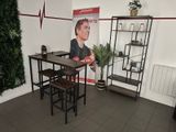 a table and chairs in a room with a poster on the wall