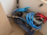 a blue machine that is sitting in the corner of a room