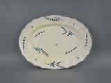 blue and white plate with blue flowers on it on a gray surface