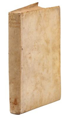 an old book sitting on top of a white surface