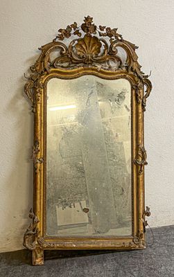 un miroir posé sur le sol à côté d'un mur