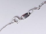 sterling silver bracelet with oval links and a clasp with a red stone