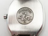 a silver watch with a metal band and a silver watch face with a lion on it