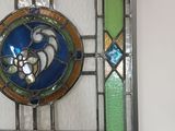 a picture of a stained glass window hanging on the wall