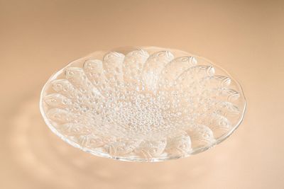 a clear glass bowl with a flower design on it