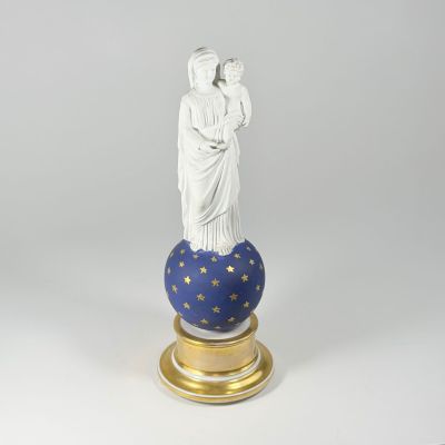 a statue of a woman holding a child on top of a globe