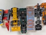 several toy trains are lined up in a row on a white surface