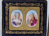 pair of miniature porcelain portraits of two women in a gold frame