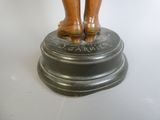 a bronze statue of a woman standing on a pedestal