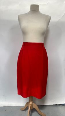 red skirt on a mannequin stand against a white backdrop