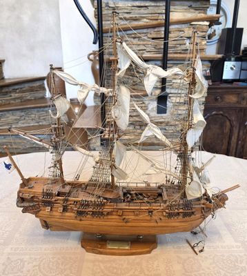 a wooden model of a ship on a table