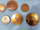 four different types of coins are shown on a blue surface