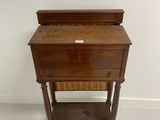 an old wooden desk with a drawer on top of it