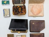 many different types of purses and wallets laid out on a table