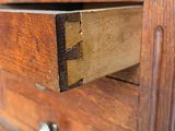 a close up of a wooden drawer with a drawer underneath it