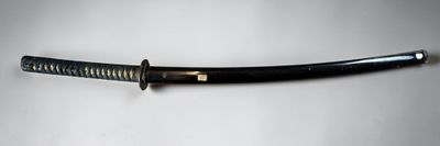 a close up of a knife on a table with a white background