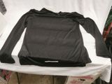 a black shirt sitting on top of a white table