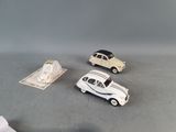 three toy cars sitting next to each other on a table
