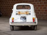 a small white car with a surfboard on the back of it