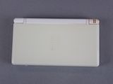 nintendo wii game console with a white cover and a white pen