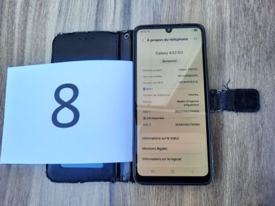 a cell phone that is open on a table with a notepad