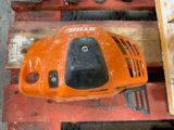 an orange lawn mower sitting on top of a wooden pallet