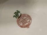 a white plate with a red and green design on it