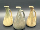three vases sitting side by side on a table