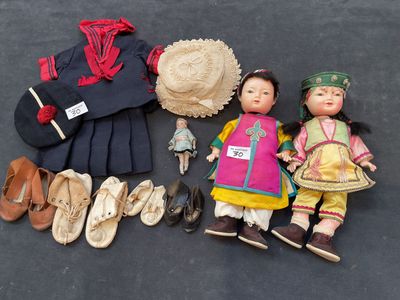 a lot of dolls that are sitting on the floor