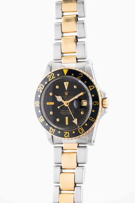 an image of a black and gold wrist watch on a white background