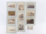 several old photographs of trees and buildings are displayed on a wall