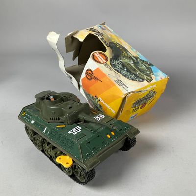 a toy tank that is sitting next to a box