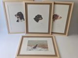 three framed prints of dogs on a white surface