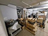 a room with a lot of boxes and pallets in it