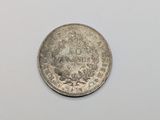 a close up of a coin on a white surface