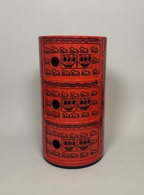 a red vase with a lot of different designs on it