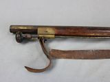 a very old gun that is laying on a table